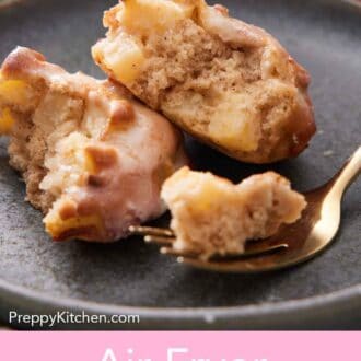 Pinterest graphic of an air fryer apple fritter on a plate, cut in half, with a small bite on the fork in front.