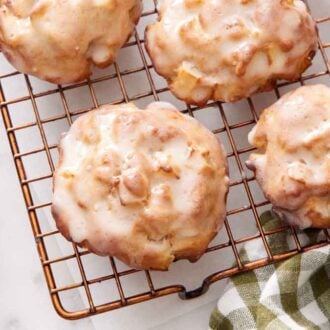 A close up view of air fryer apple fritters on a cooling rack.