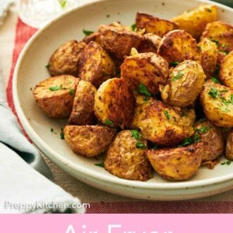 Pinterest graphic of a plate of air fryer potatoes topped with chopped parsley.