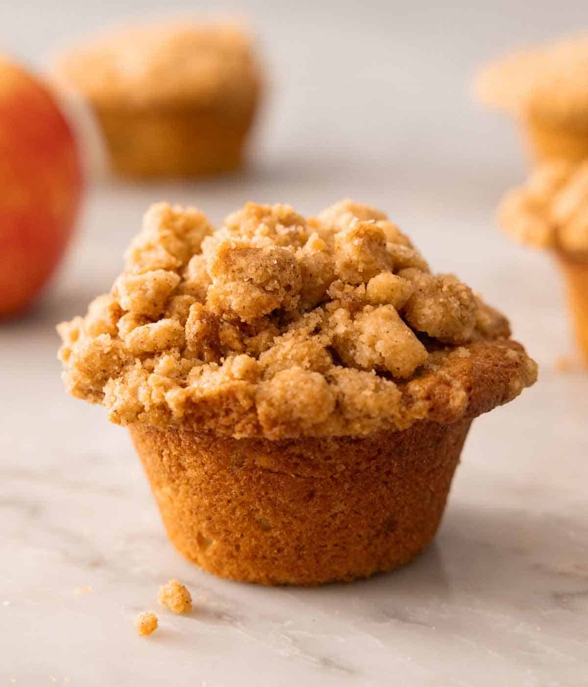 An apple muffin on a counter.