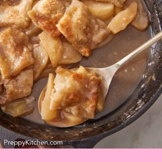 Pinterest graphic of a spoon inside of a cast iron skillet of apple pandowdy.