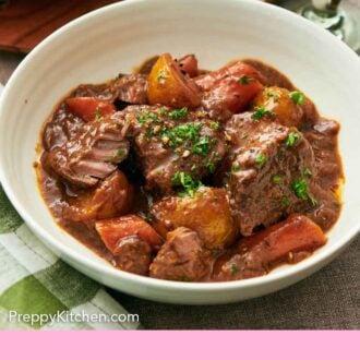 Pinterest graphic of a bowl of lamb stew with chopped parsley on top.