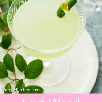 Pinterest graphic of a glass of Last Word Cocktail with a lime zest garnish on a serving platter with some green leaves.