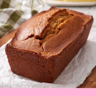 Pinterest graphic of a loaf of pumpkin bread on a parchment-lined cutting board.