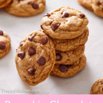 Pinterest graphic of stack of pumpkin chocolate chip cookies with one leaning on them.