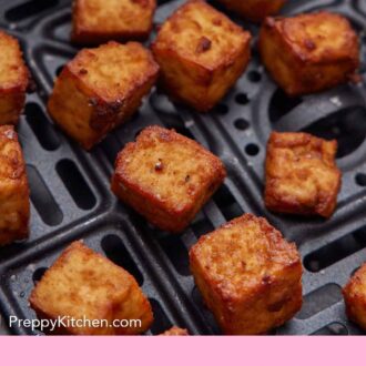 Pinterest graphic of a close up view of air fryer tofu in an air fryer basket.