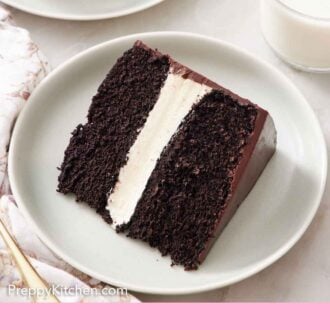 Pinterest graphic of a plated slice of Ding Dong cake. A glass of milk off to the side.