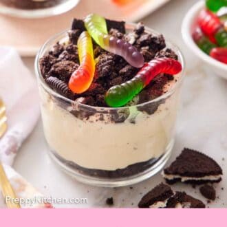 Pinterest graphic of a cup of dirt cake topped with gummy bears.