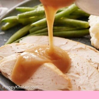 Pinterest graphic of gravy poured over sliced turkey meat on a plate with green beans.