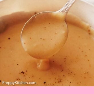 Pinterest graphic of a spoonful of gravy lifted from a pot with pepper on top.