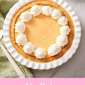 Pinterest graphic of an overhead view of a pie dish with a no-bake pumpkin cheesecake topped with dollops of whipped cream.