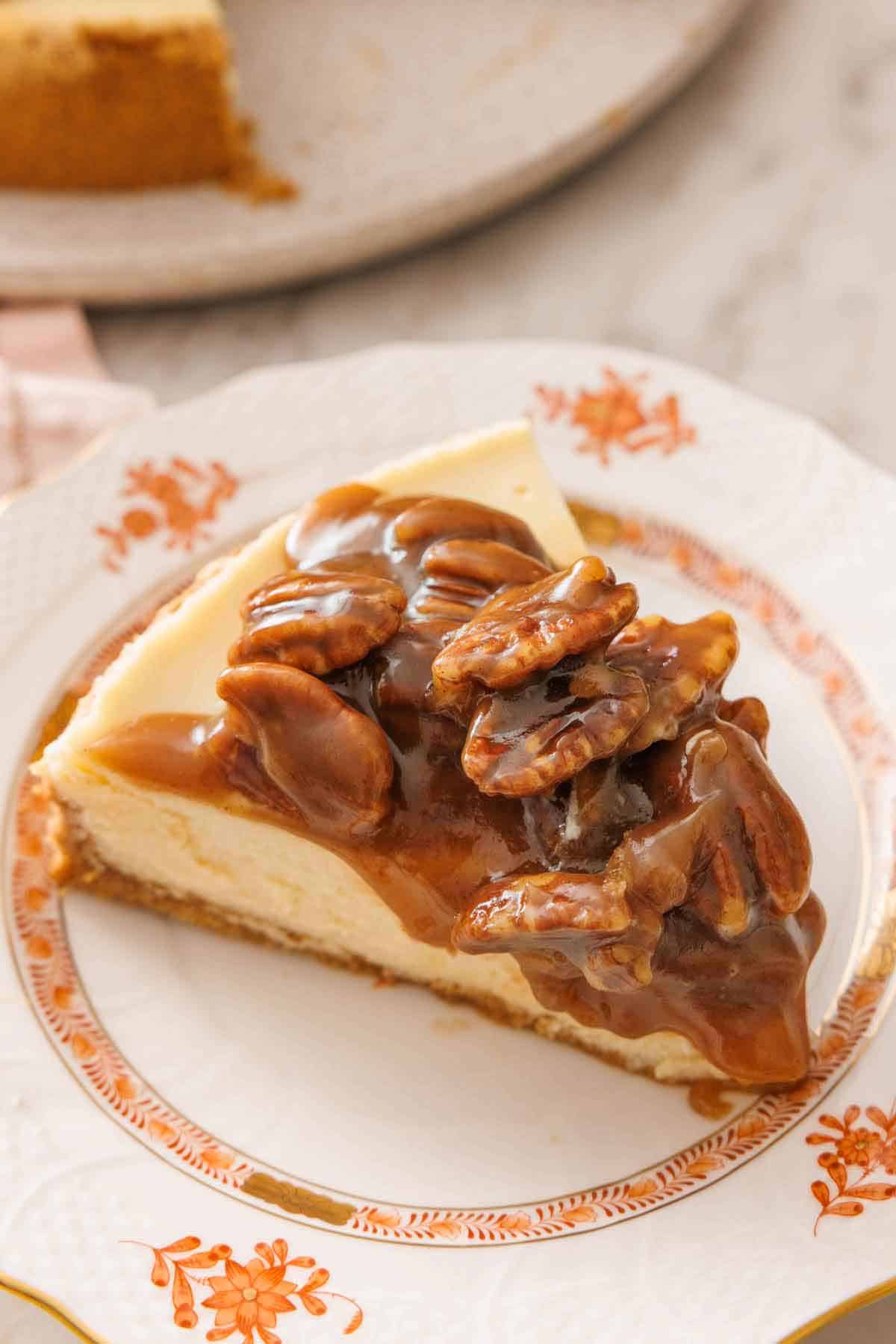 A slice of pecan pie cheesecake on a plate.