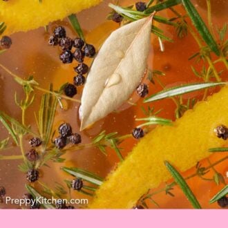 Pinterest graphic of a close up view of the herbs, peppercorn, and orange zest in turkey brine.