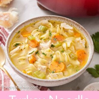 Pinterest graphic of a bowl of turkey noodle soup in front of a red pot of more soup.