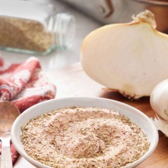 Pinterest graphic of a bowl of turkey seasoning with roasted turkey ingredients in the background.