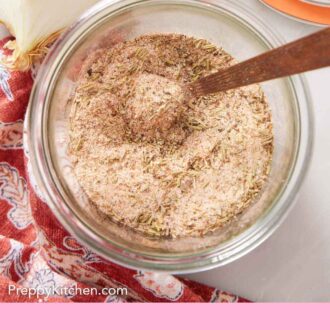 Pinterest graphic of an overhead view of a jar of turkey seasoning with a spoon.