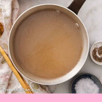 Pinterest graphic of an overhead view of a pot of turkey stock.