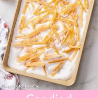 Pinterest graphic of candied orange peels in a sheet pan of sugar.