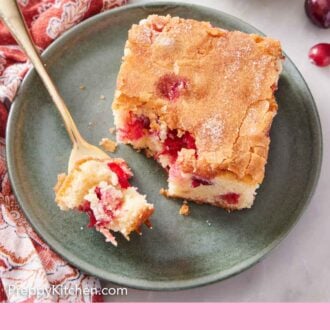 Pinterest graphic of a plate with a slice of cranberry cake with a bite on a fork.