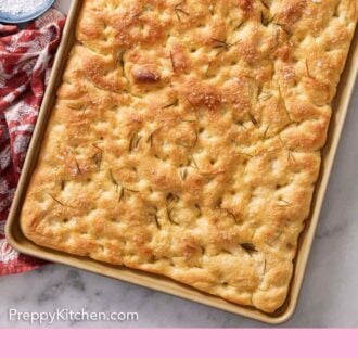 Pinterest graphic of an overhead view of a sheet pan of focaccia topped with rosemary.