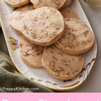 Pinterest graphic of a platter of pecan shortbread cookies with a small vase of flowers on the side.