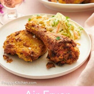 Pinterest graphic of a plate with two pieces of air fryer fried chicken along with coleslaw.