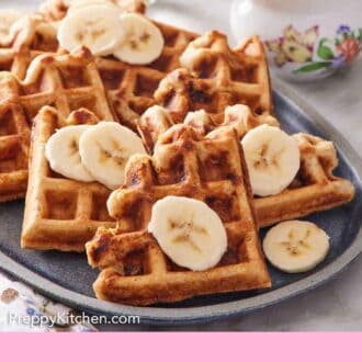 Pinterest graphic of a platter with pieces of banana waffles topped with sliced bananas.