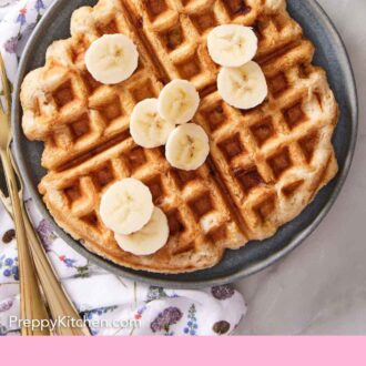 Pinterest graphic of a plate of banana waffle topped with sliced bananas.