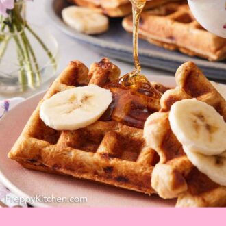 Pinterest graphic of syrup being poured onto a piece of banana waffle with banana slices.