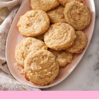 Pinterest graphic of a pink platter with multiple coconut cookies.