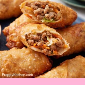 Pinterest graphic of a stack of egg rolls with the ones on top, cut in half, showing the interior.