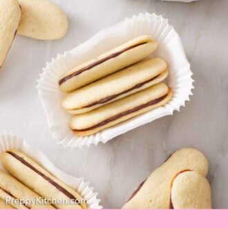 Pinterest graphic of three Milano cookies in paper holder with more surrounding the set.