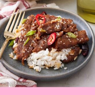 Pinterest graphic of a plate of Mongolian beef over rice, garnished with chili peppers and green onions.