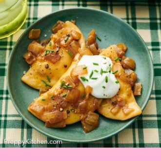 Pinterest graphic of a plate with three pierogies topped with chives and sour cream.