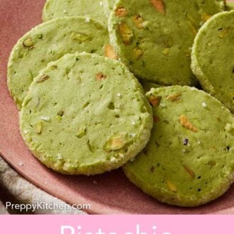 Pinterest graphic of a pink plate of pistachio matcha cookies.