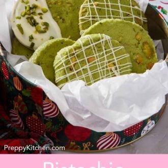 Pinterest graphic of a festive tin lined with parchment paper with pistachio matcha cookies.