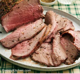 Pinterest graphic of a platter of a partially sliced roast beef.