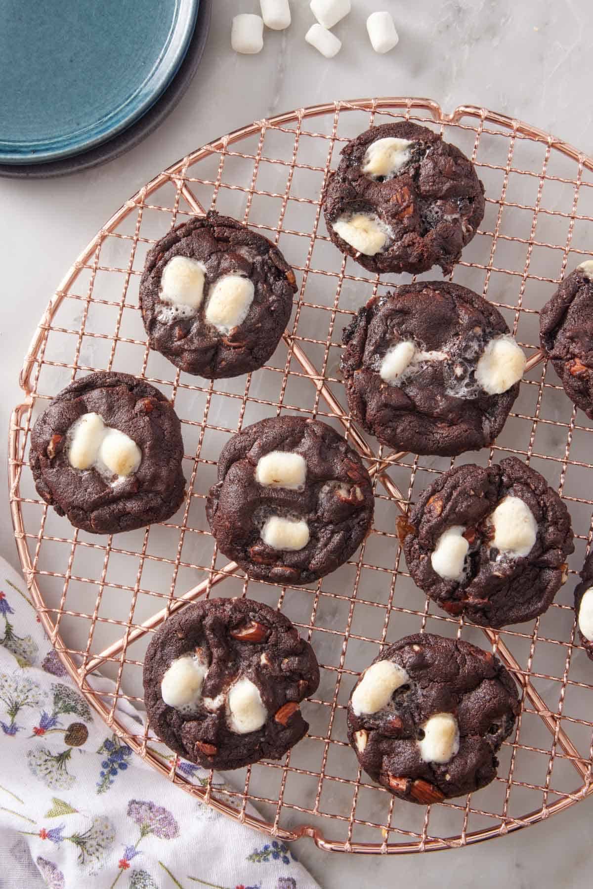 An overhead view of a cooling rack with rocky road cookies.