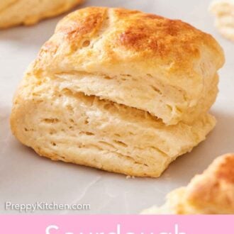 Pinterest graphic of a sourdough biscuit on a marble surface.