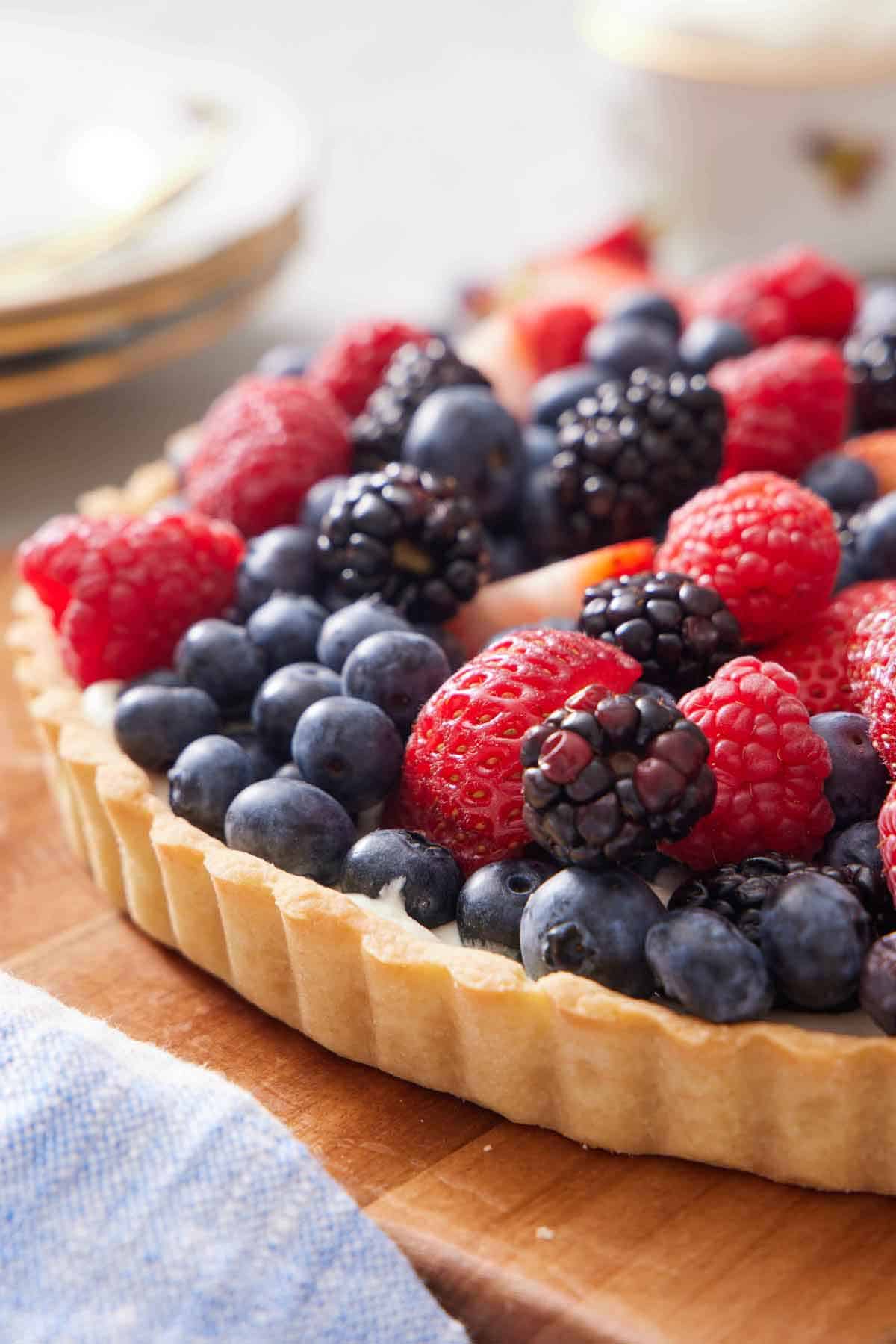 A tart crust topped with an assortment of blueberries, blackberries, raspberries, and strawberries.