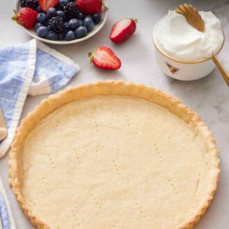 Pinterest graphic of a baked tart crust with a bowl of berries and whipped cream in the background.