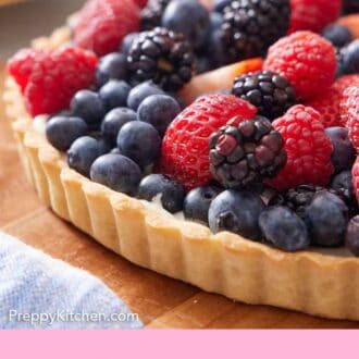 Pinterest graphic of a tart crust topped with an assortment of blueberries, blackberries, raspberries, and strawberries.