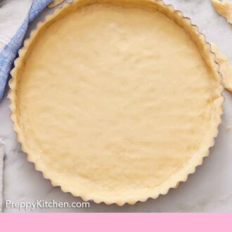 Pinterest graphic of an overhead view of a tart crust before baking with some scraps of dough on the side.