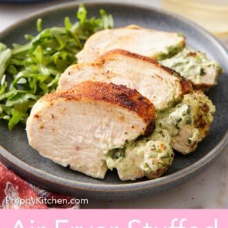 Pinterest graphic of a plate with an air fryer stuffed chicken breast sliced into a few pieces along with arugula.