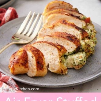 Pinterest graphic of an air fryer stuffed chicken breast on a plate, sliced.