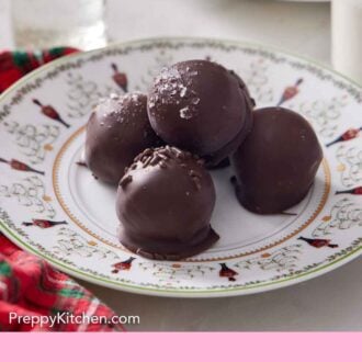 Pinterest graphic of a plate of brownie truffles with one stacked on top.