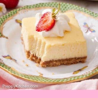 Pinterest graphic of a plate with a cheesecake bar topped with whipped cream and strawberry with a bite taken out.