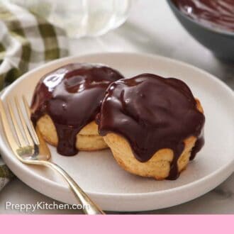 Pinterest graphic of a plate of chocolate gravy over two biscuits with a fork beside a biscuit.