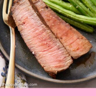 Pinterest graphic of a close up view of sliced London broil on a plate with green beans and a fork.