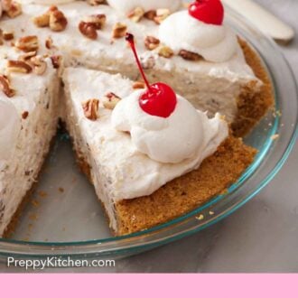 Pinterest graphic of a slice of Millionaire Pie sliced in the pie dish, topped with chopped pecans, whipped cream, and maraschino cherries.